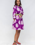 Model wearing purple and white floral print dress.