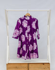 Display of purple and white floral print dress.