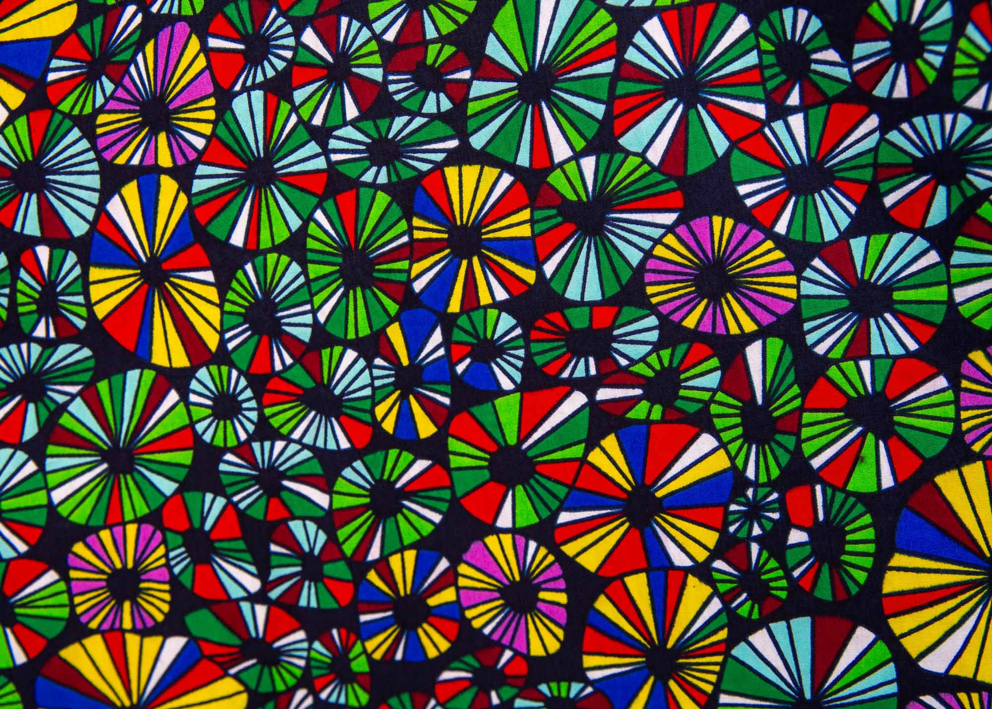 Close up display of navy blue dress with rainbow color umbrella shaped print