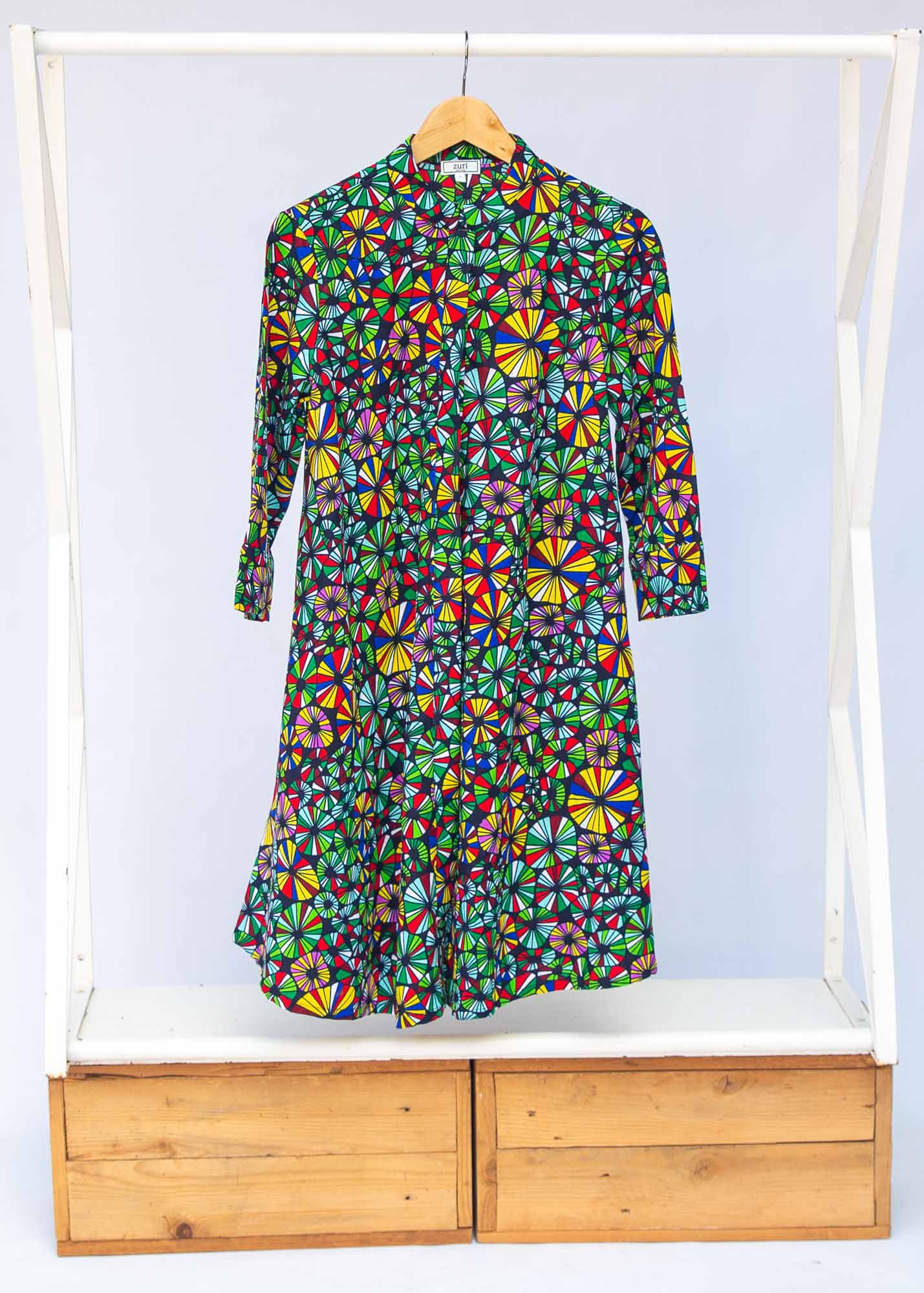 Display of navy blue dress with rainbow color umbrella shaped print