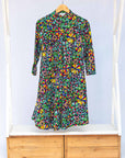 Display of navy blue dress with rainbow color umbrella shaped print