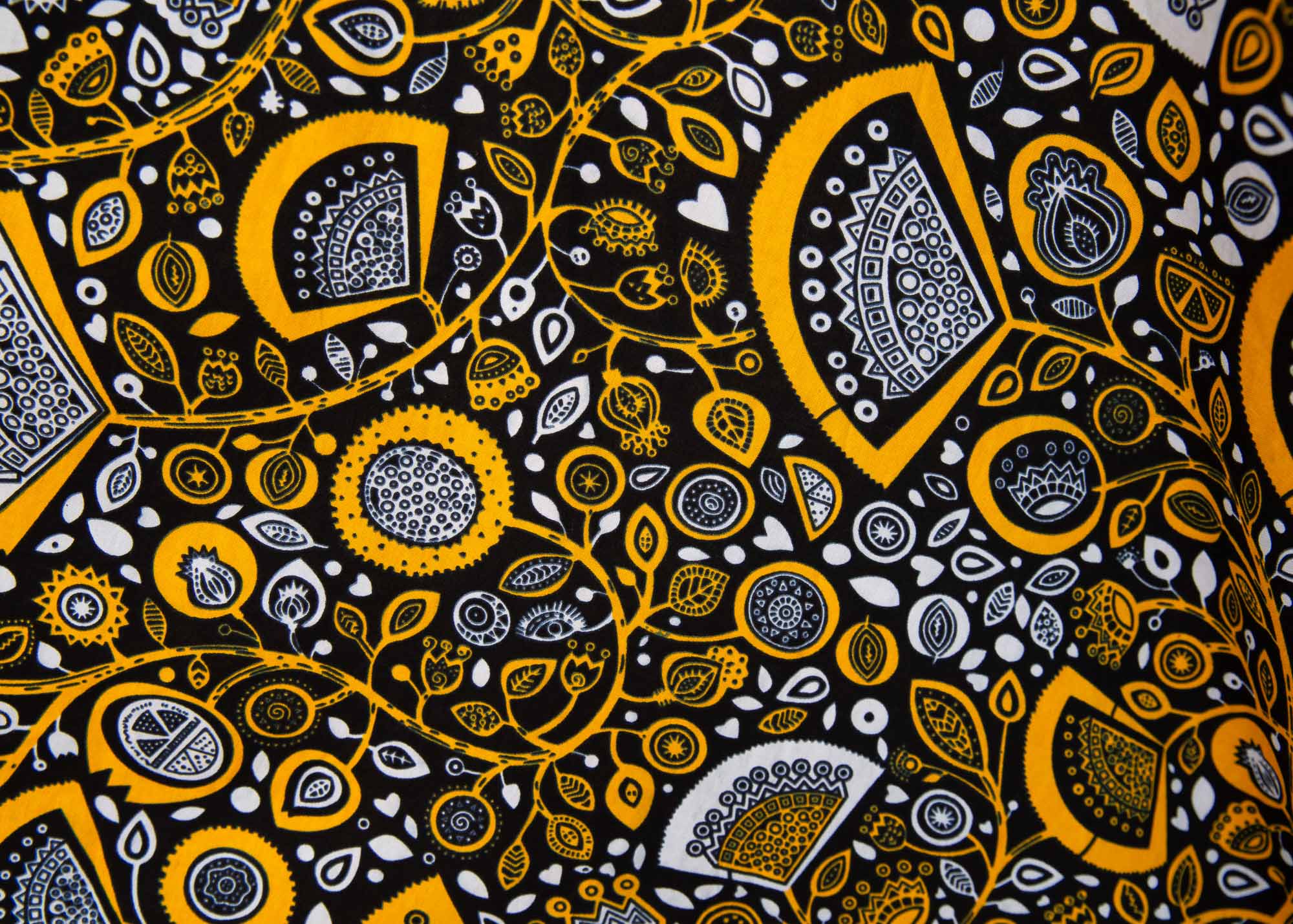 Close up display of black dress with white and yellow botanical print