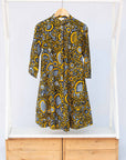 Display of black dress with white and yellow botanical print