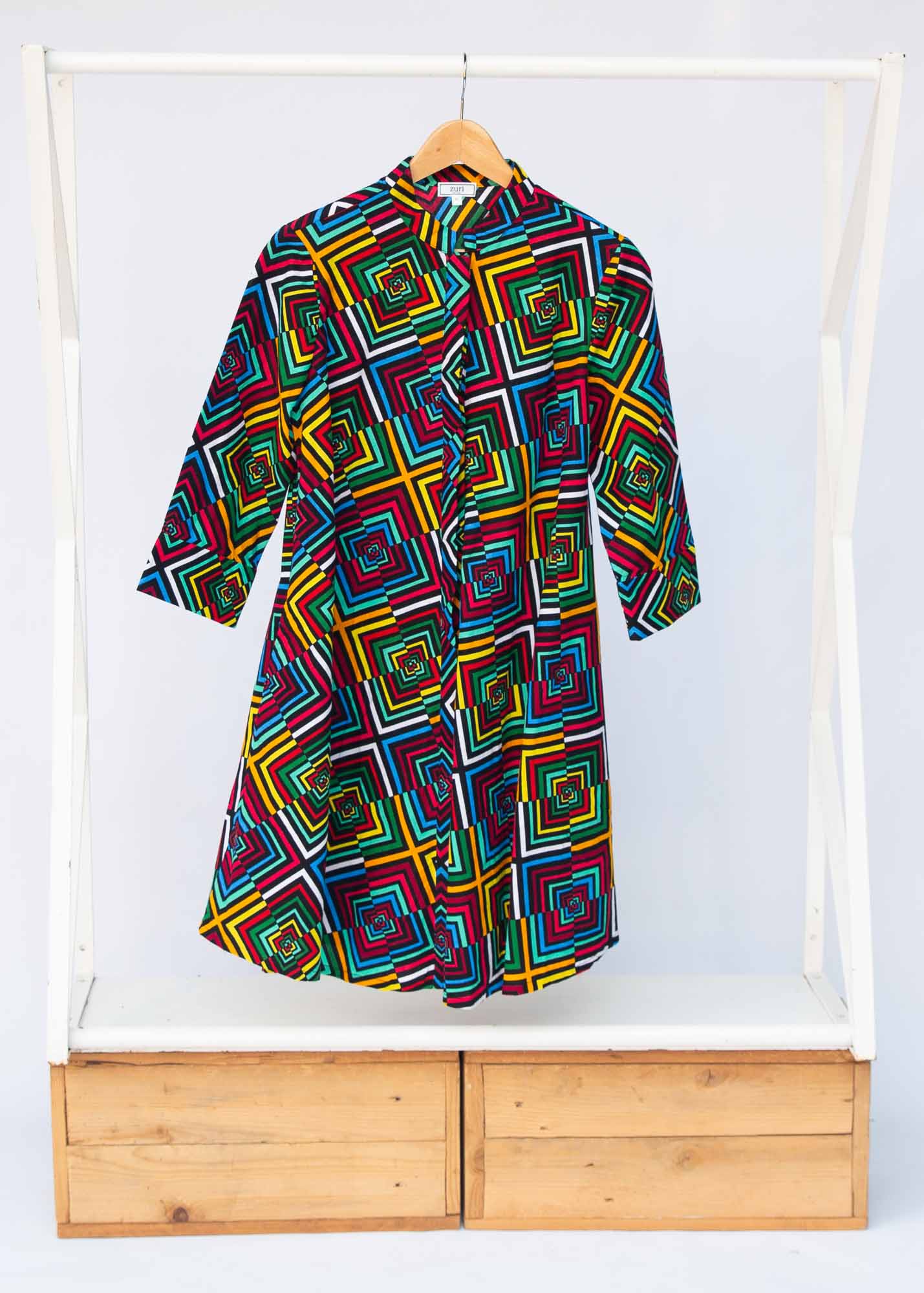Display of geometric print with rainbow colored dress