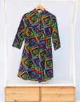 Display of geometric print with rainbow colored dress