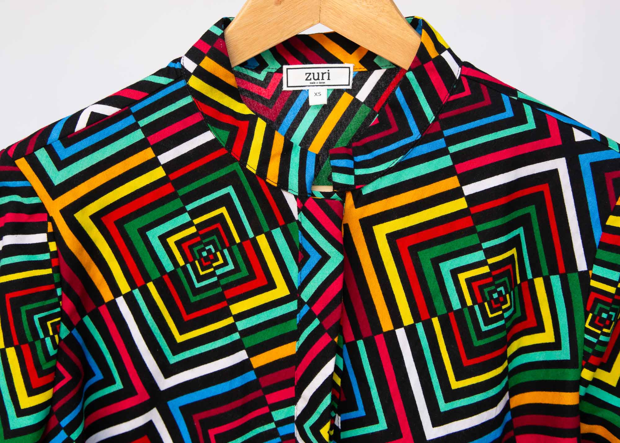 Display of geometric print with rainbow colored dress