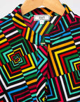 Display of geometric print with rainbow colored dress