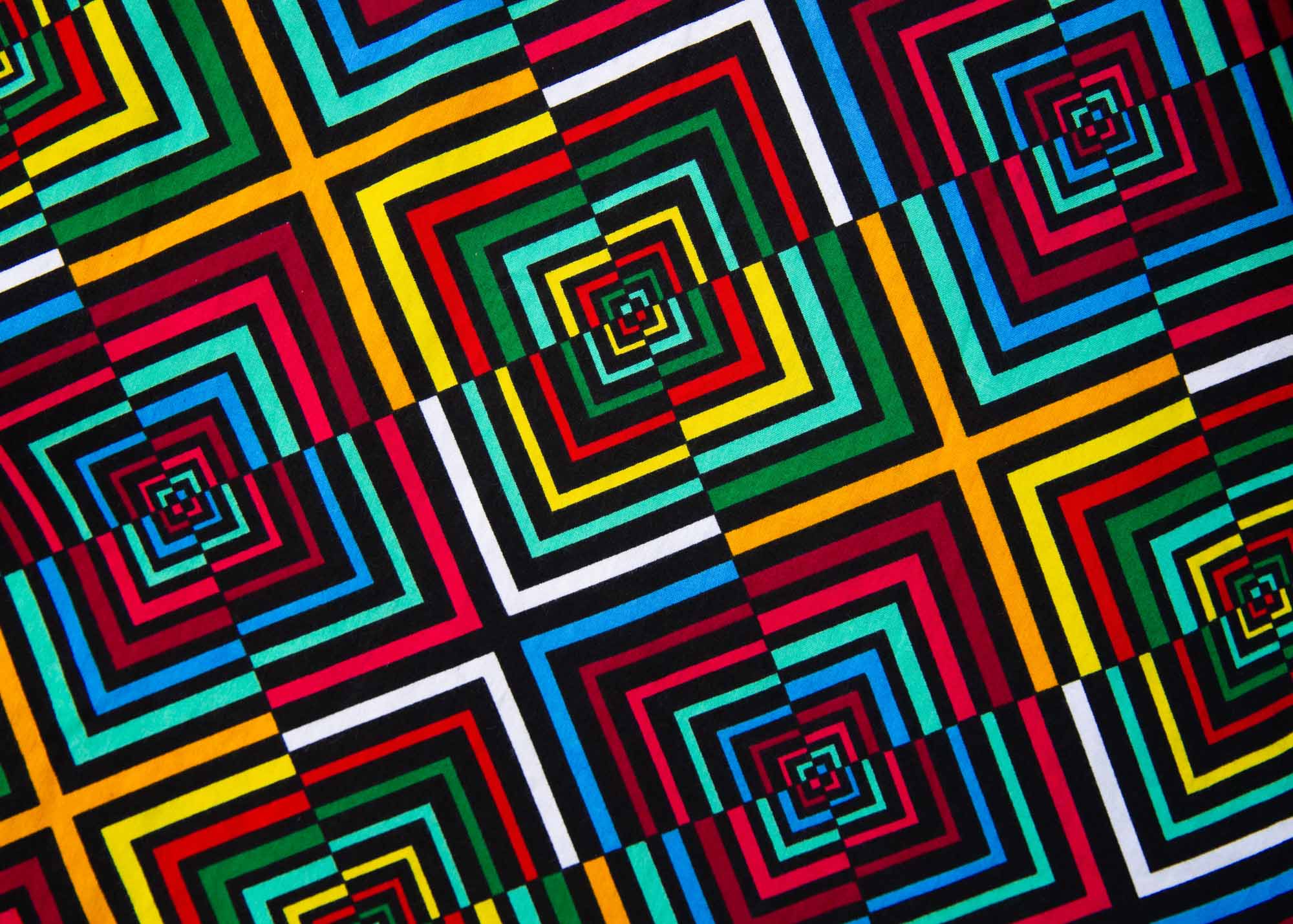 Close up display of geometric print with rainbow colored dress