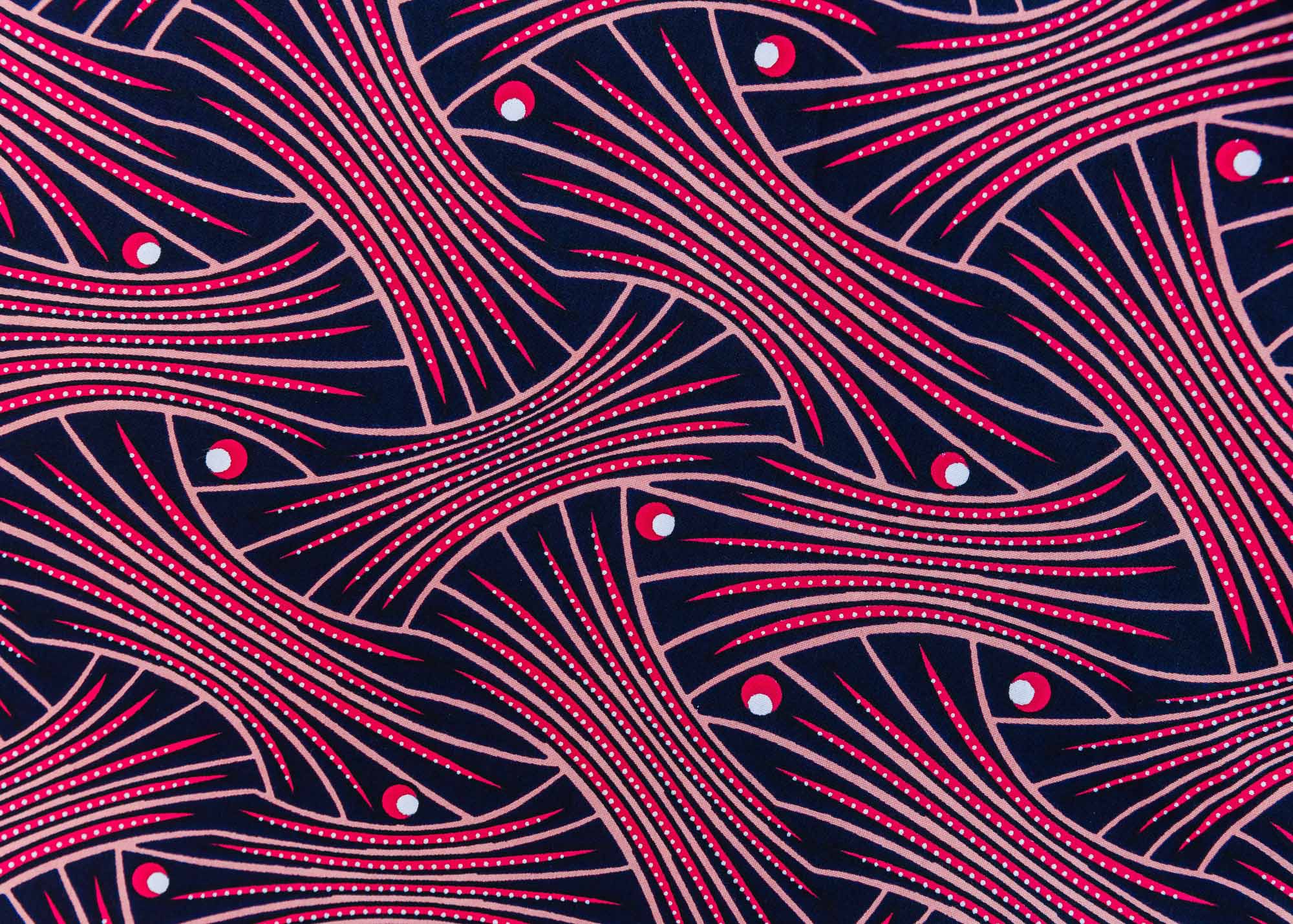 Close up display of coral, pink, white and navy blue colored dress, fabric