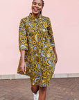 The model is wearing black dress with white and yellow botanical print