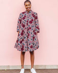 The model is wearing Burgundy, white and navy blue floral print dress