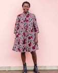 The model is wearing Burgundy, white and navy blue floral print dress