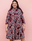 The model is wearing Burgundy, white and navy blue floral print dress