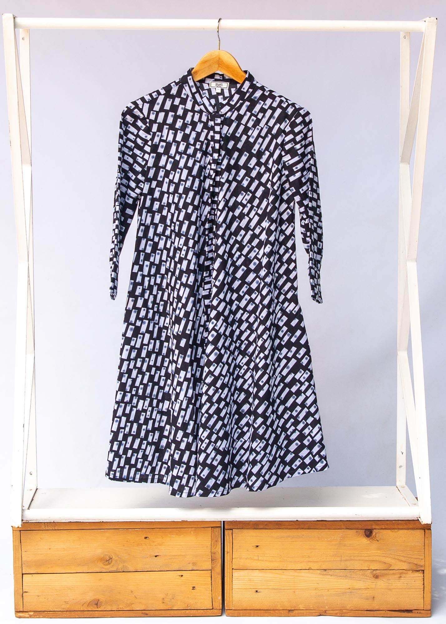Display of black dress with white rectangles