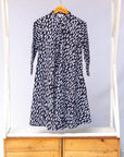 Display of black dress with white rectangles
