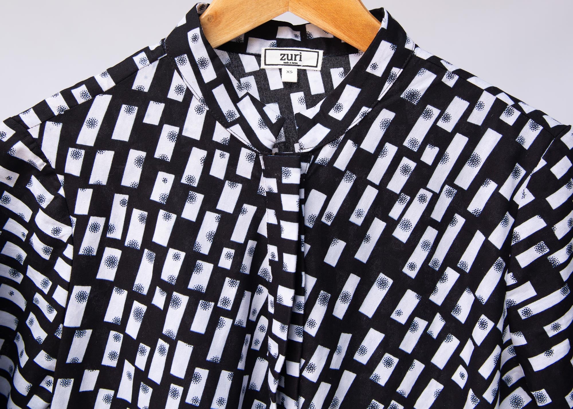 Display of black dress with white rectangles