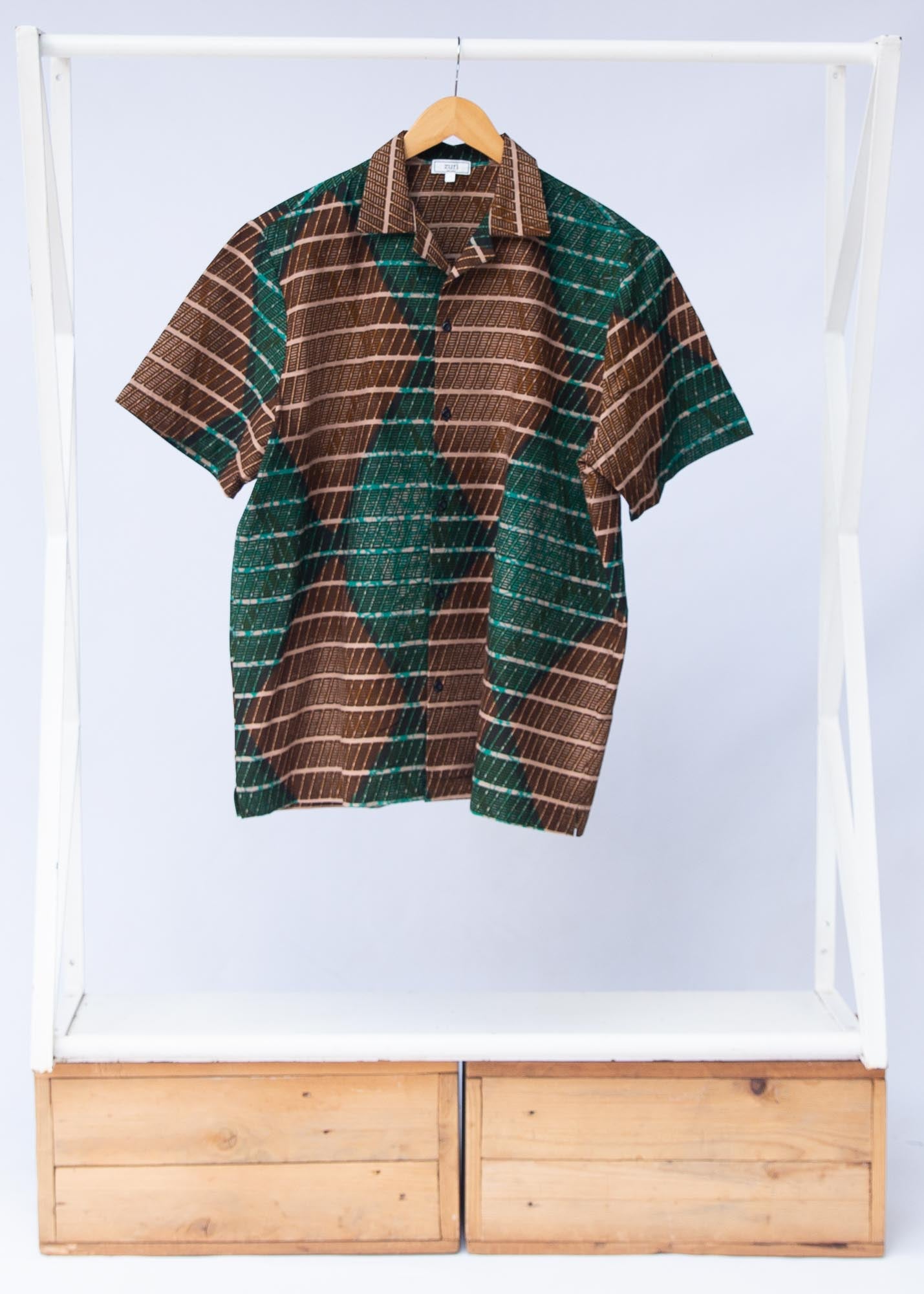 Display of  brown, camel, green and black diamond shaped geometric print shirt