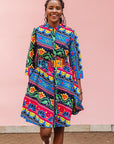 The model is wearing colorful mandala print dress