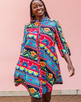 The model is wearing colorful mandala print dress