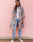 The model is wearing multi-colored paisley print dress