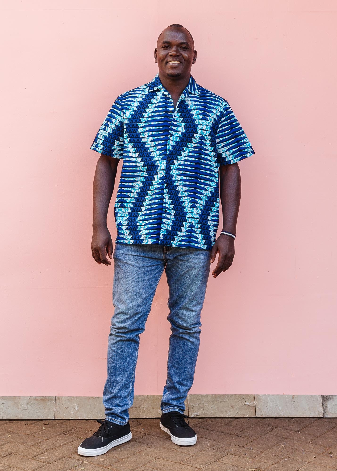 The model is wearing blue, sky blue and white colored men's shirt