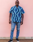 The model is wearing blue, sky blue and white colored men's shirt