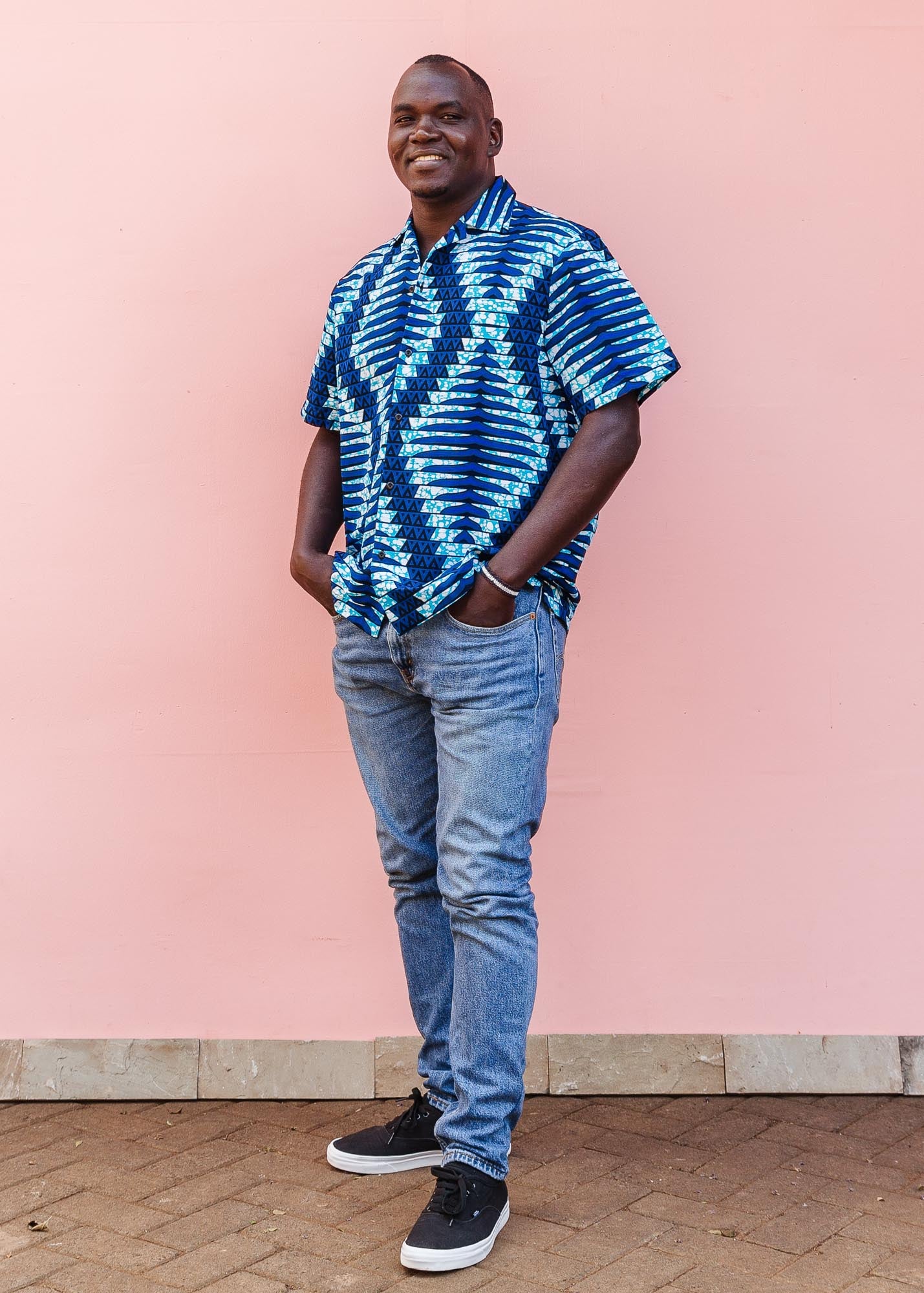 The model is wearing blue, sky blue and white colored men's shirt