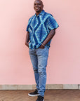 The model is wearing blue, sky blue and white colored men's shirt