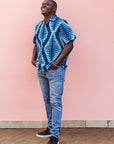 The model is wearing blue, sky blue and white colored men's shirt