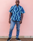 The model is wearing blue, sky blue and white colored men's shirt