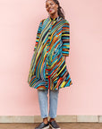 The model is wearing pop art colored geometric print
