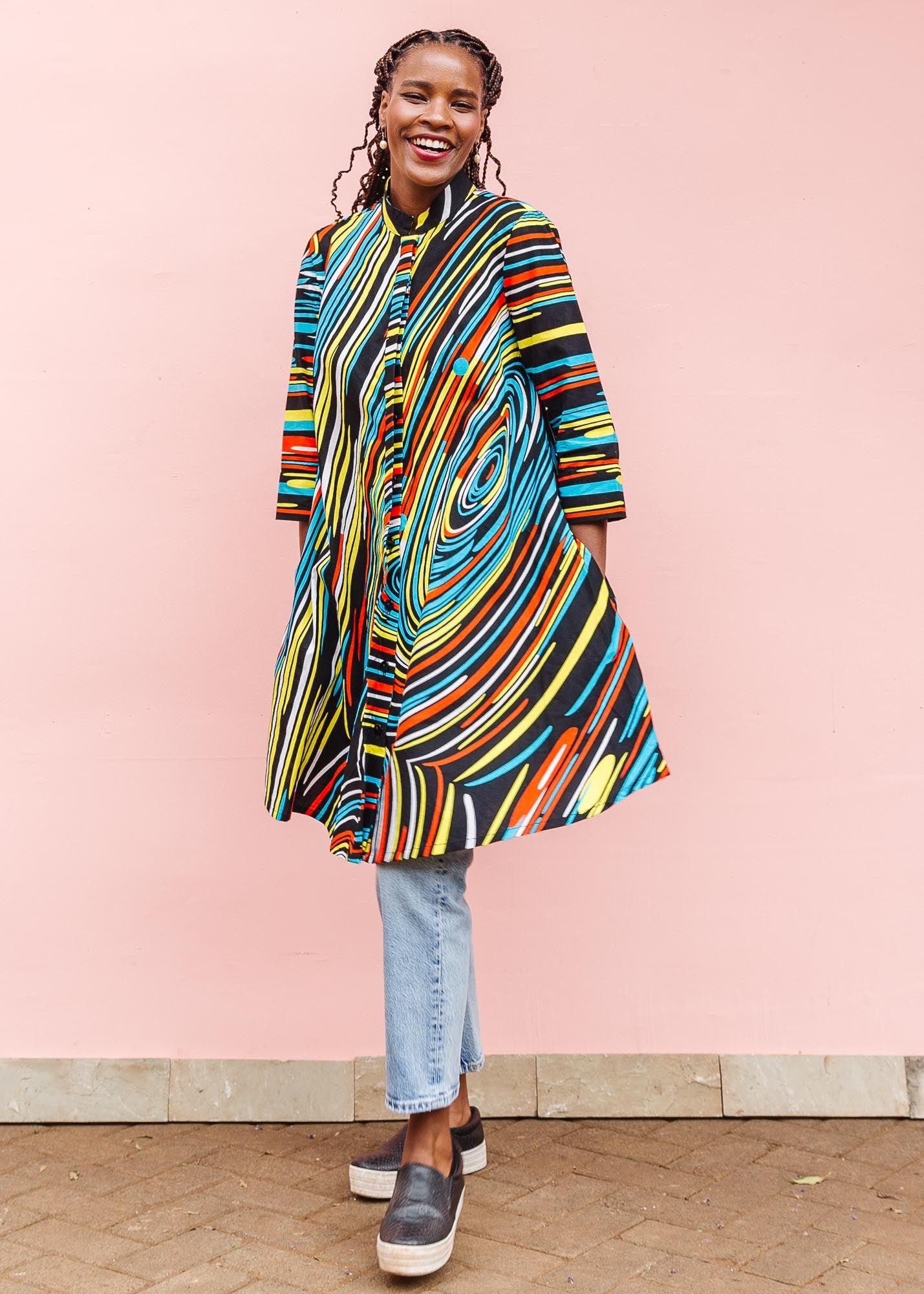 The model is wearing pop art colored geometric print