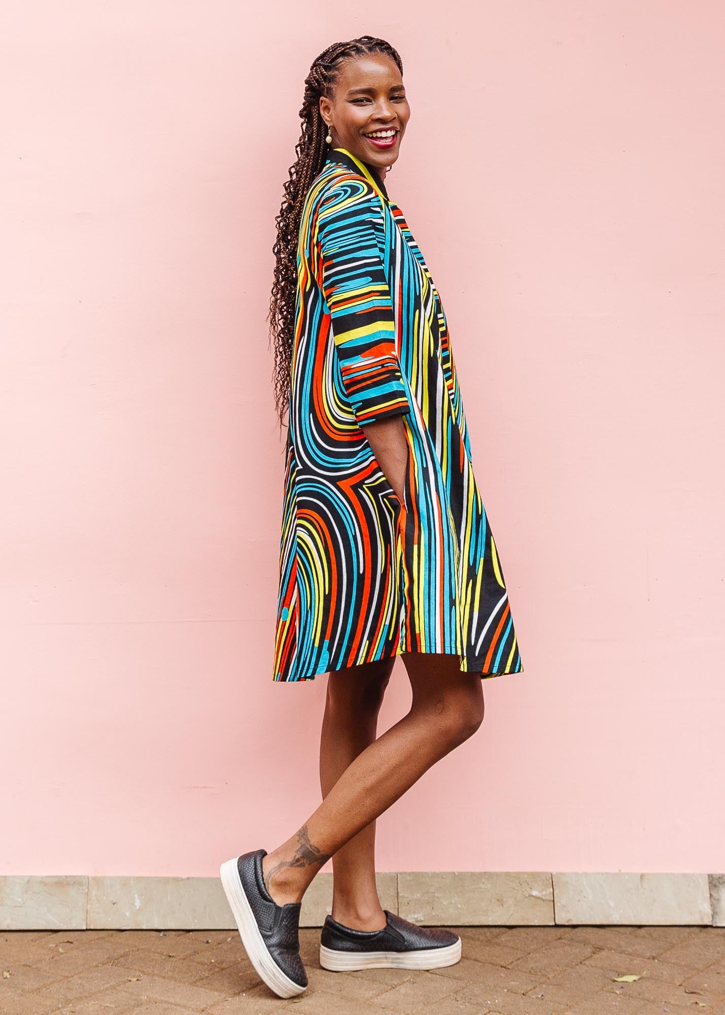 The model is wearing pop art colored geometric print