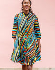 The model is wearing pop art colored geometric print