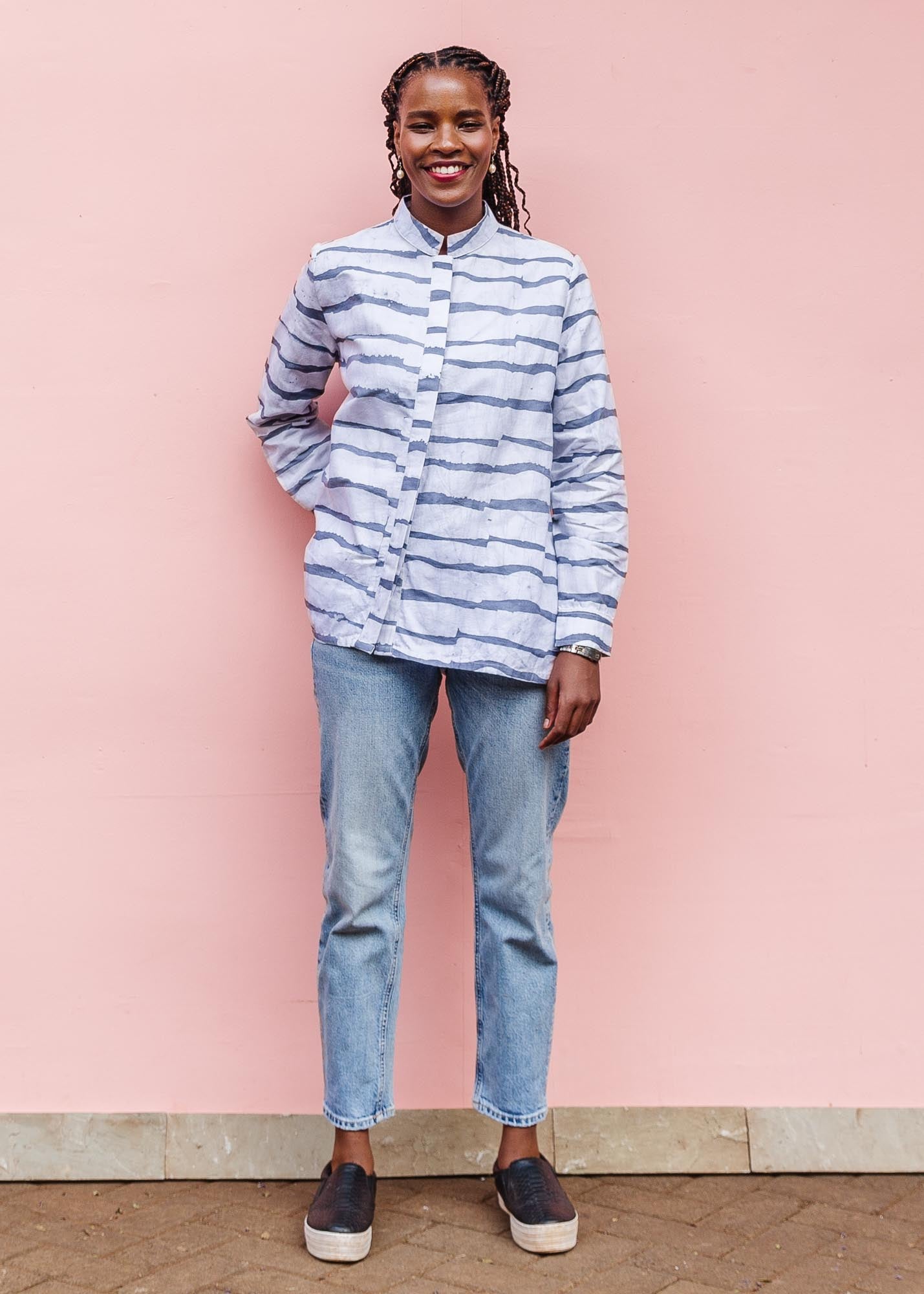 The model is wearing gray and white striped batik shirt