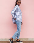 The model is wearing gray and white striped batik shirt