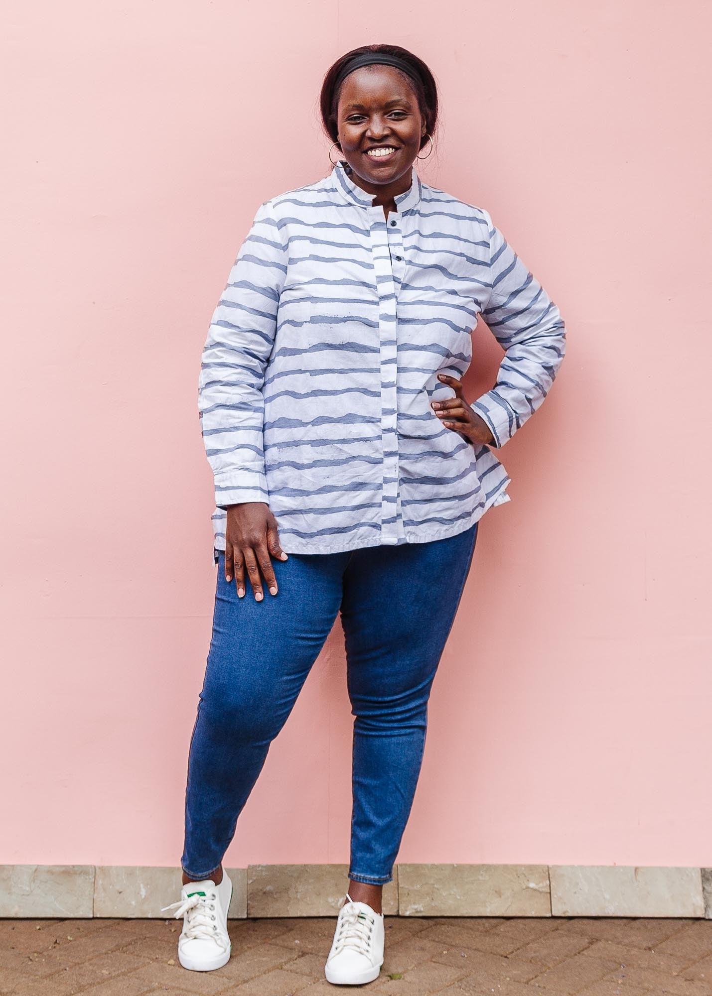 The model is wearing gray and white striped batik shirt