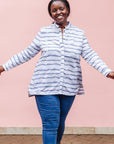 The model is wearing gray and white striped batik shirt