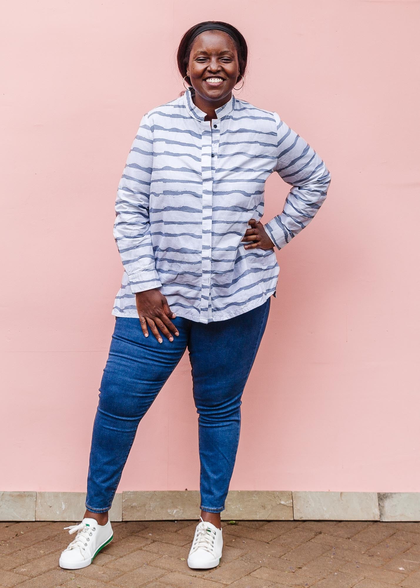 The model is wearing gray and white striped batik shirt