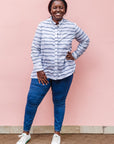The model is wearing gray and white striped batik shirt