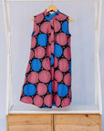 Display of coral, blue and black circular print dress