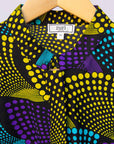 Display of black dress with purple , yellow and turquoise dotted fans