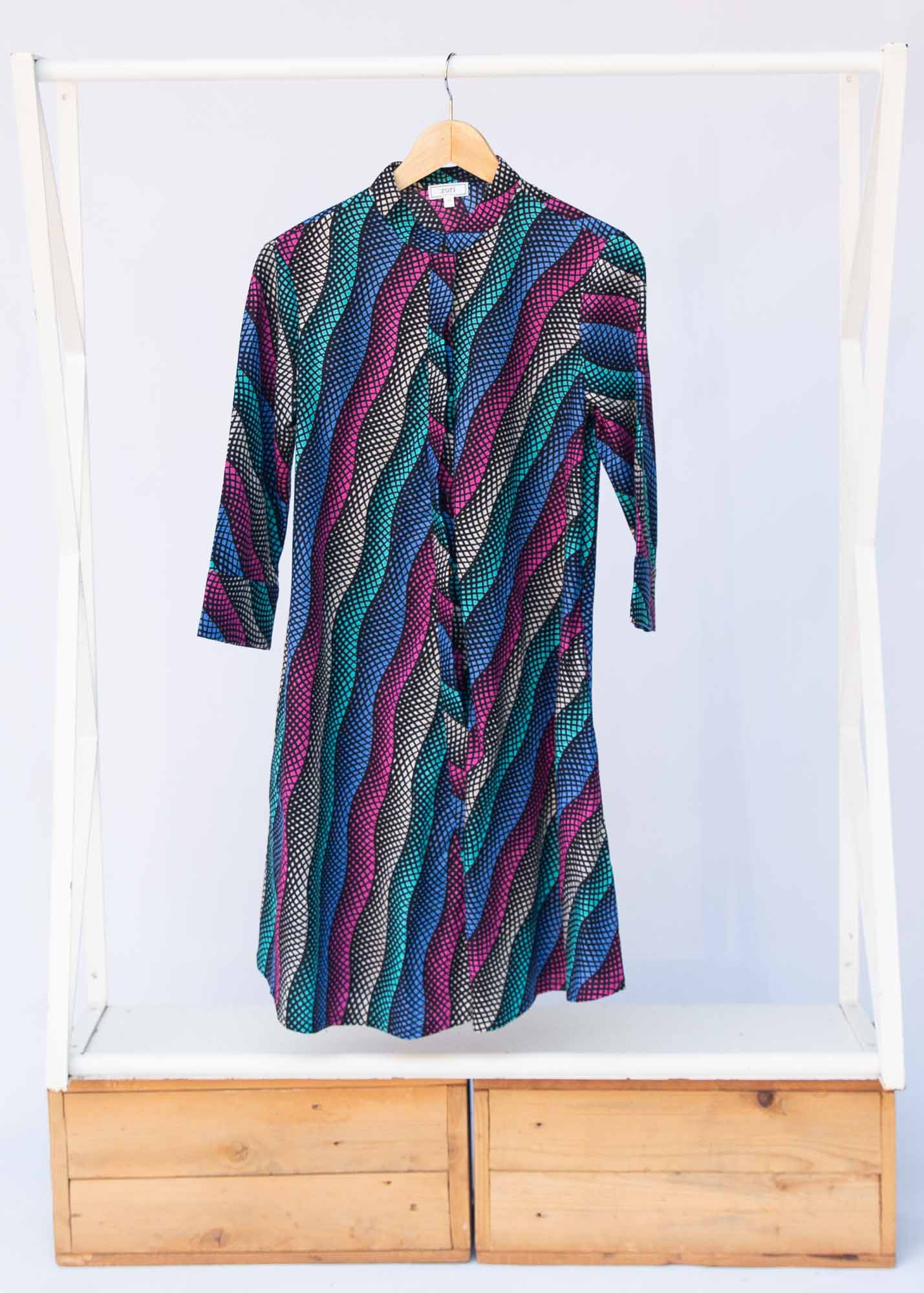 Display of pink, blue, turquoise and beige abstract line dress.