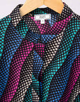 Display of pink, blue, turquoise and beige abstract line dress.