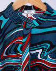 Display of turquoise, black, slate, white and red abstract print dress