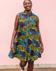 The model is wearing black dress with purple , yellow and turquoise dotted fans