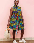 The model is wearing black dress with purple , yellow and turquoise dotted fans