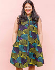 The model is wearing black dress with purple , yellow and turquoise dotted fans