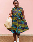 The model is wearing black dress with purple , yellow and turquoise dotted fans