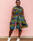 The model is wearing black dress with purple , yellow and turquoise dotted fans